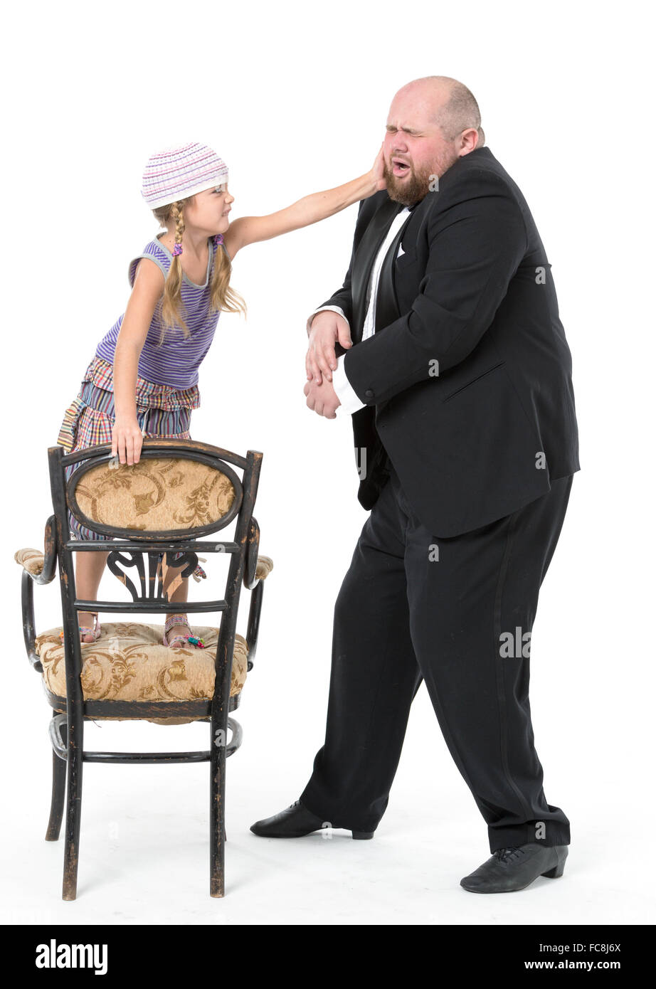 Little Girl and Servant in Tuxedo Have Fun Stock Photo