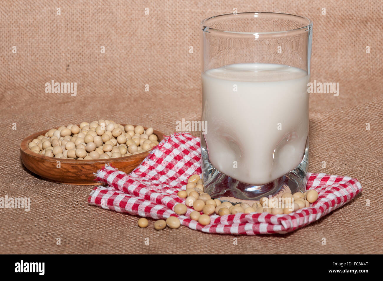 Glass of milk and bowl with soy Stock Photo
