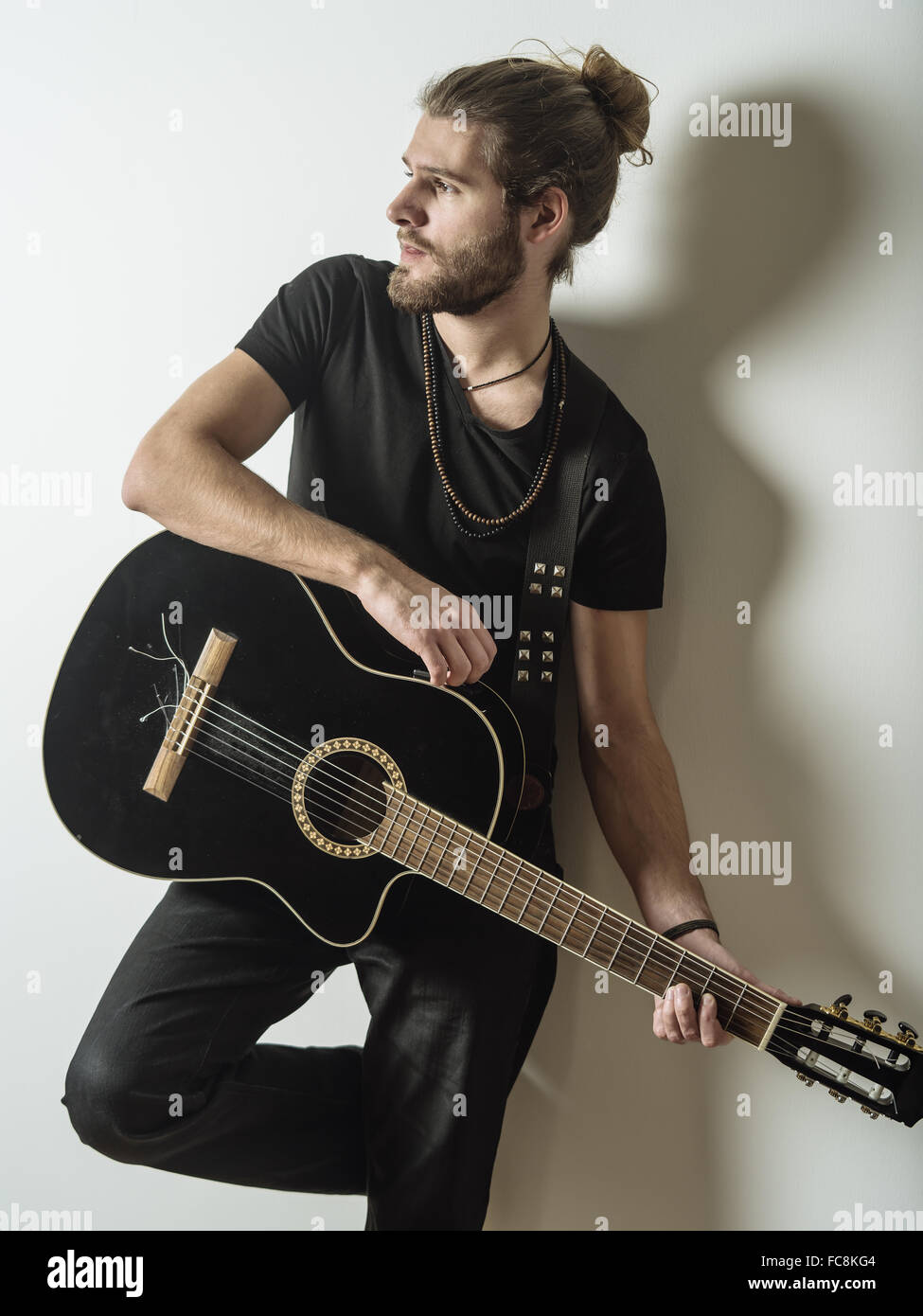 Photo Of A Young Attractive Man With Long Hair And Beard Leaning