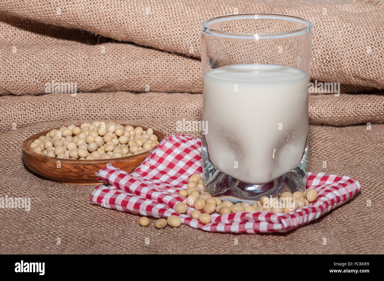 Glass of milk and bowl with soy Stock Photo