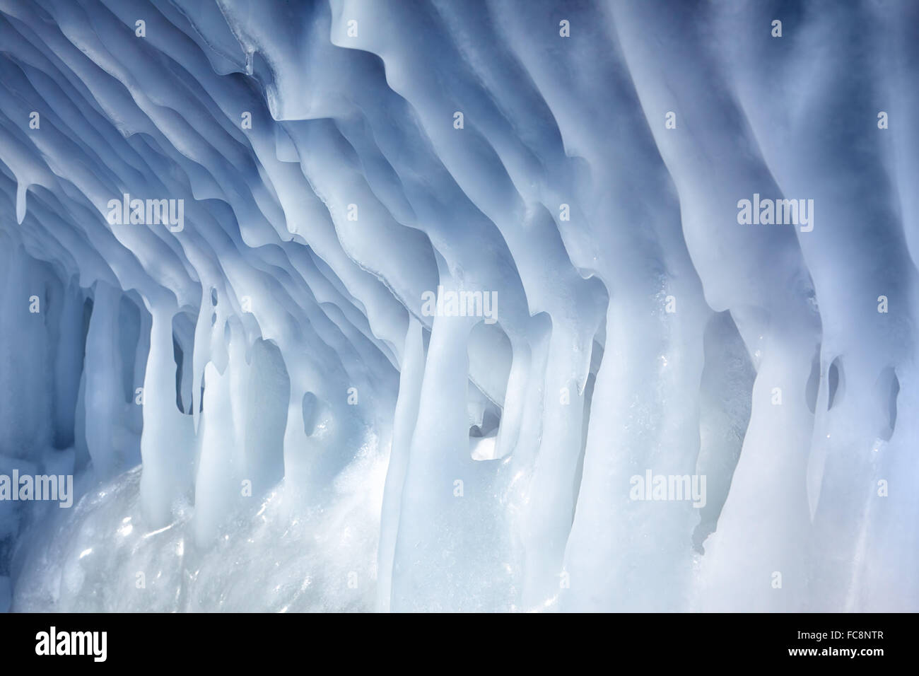 Icicles on the wall of ice cave Stock Photo