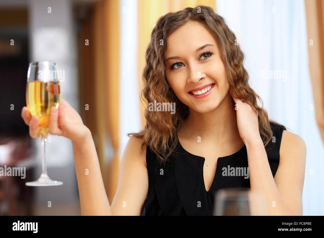 Portrait of a young pretty woman sitting in restaurant Stock Photo - Alamy