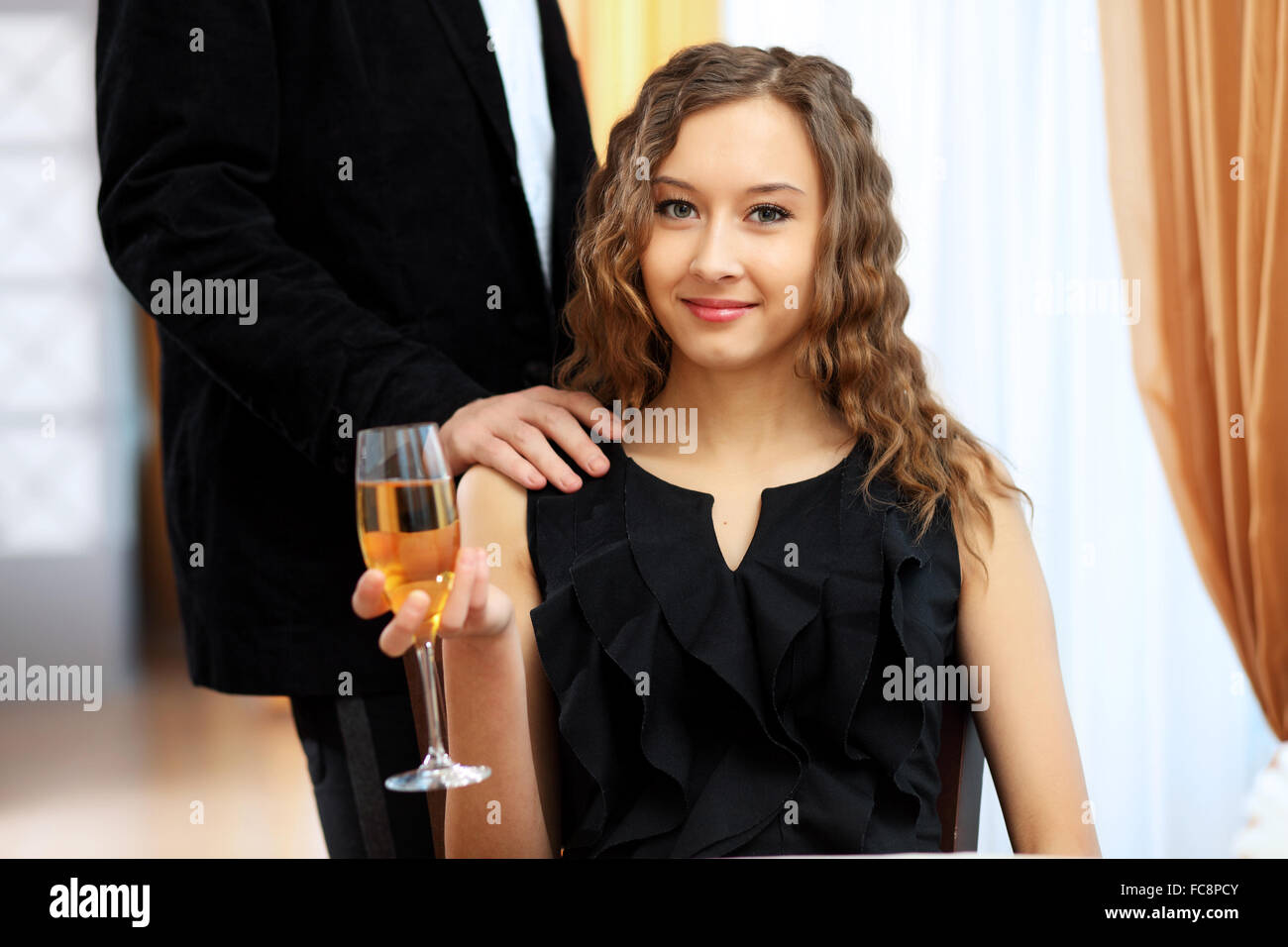 Portrait of a young pretty woman sitting in restaurant Stock Photo - Alamy