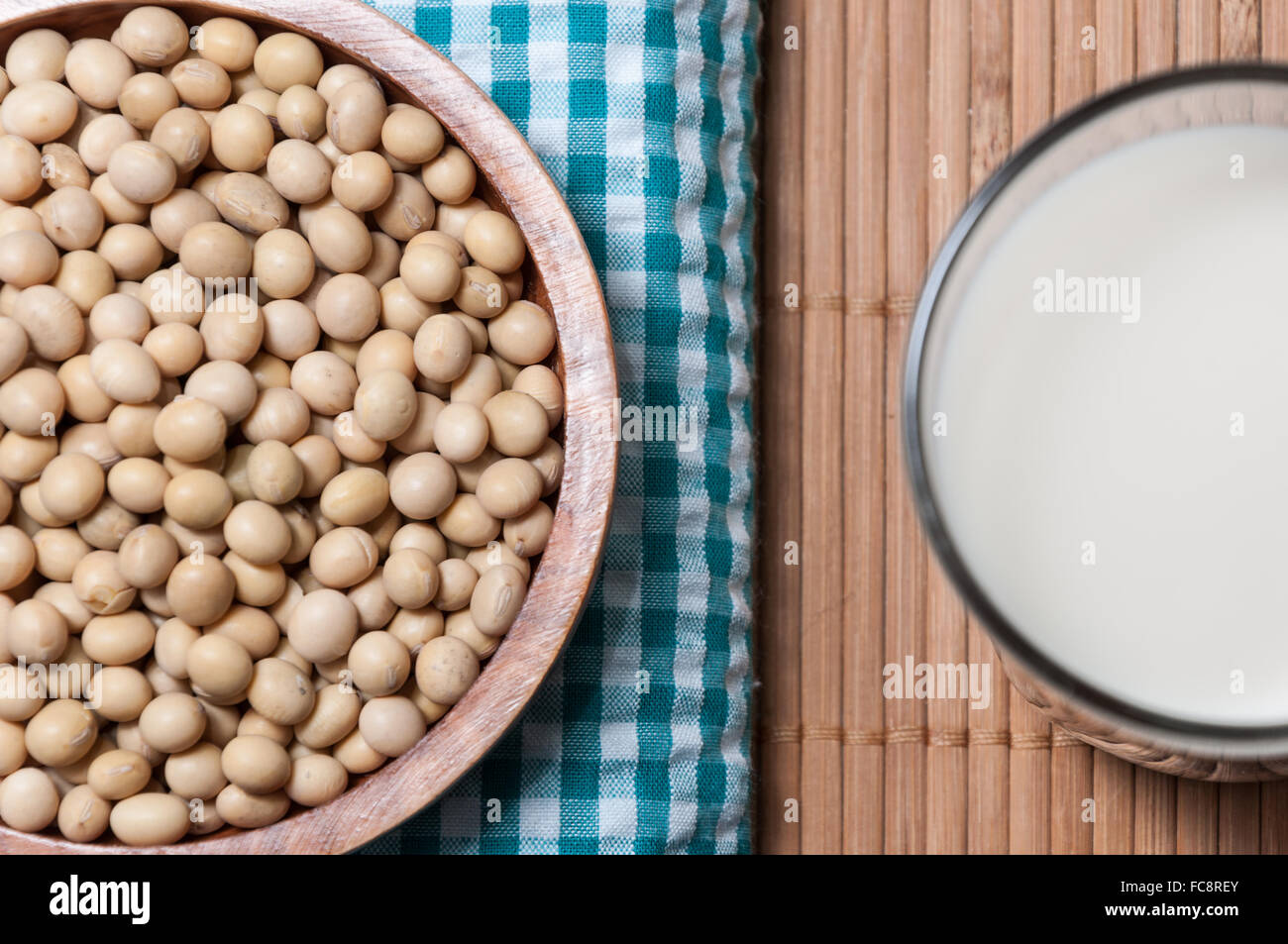 Glass of milk and bowl with soy Stock Photo