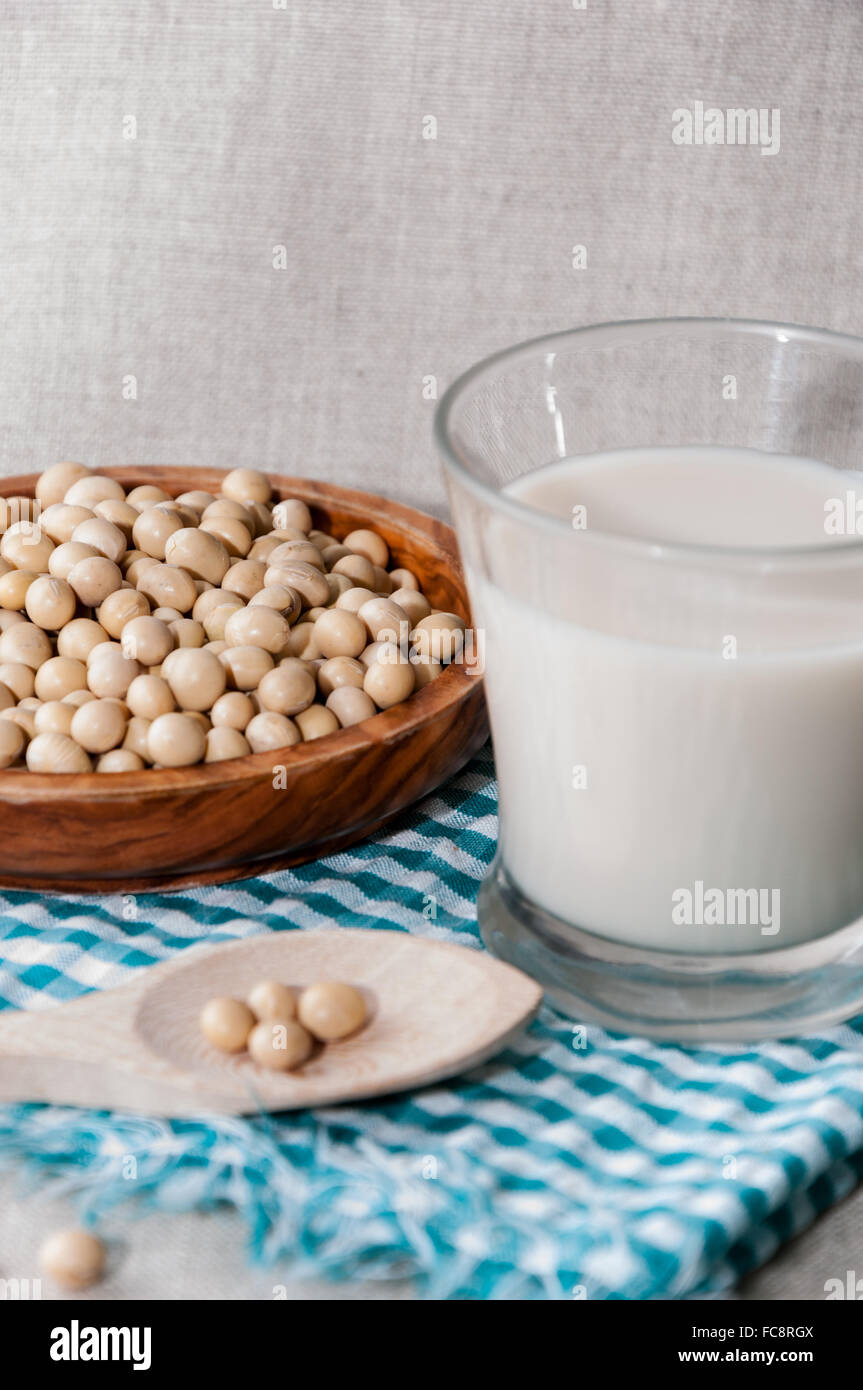 Glass of milk and bowl with soy Stock Photo