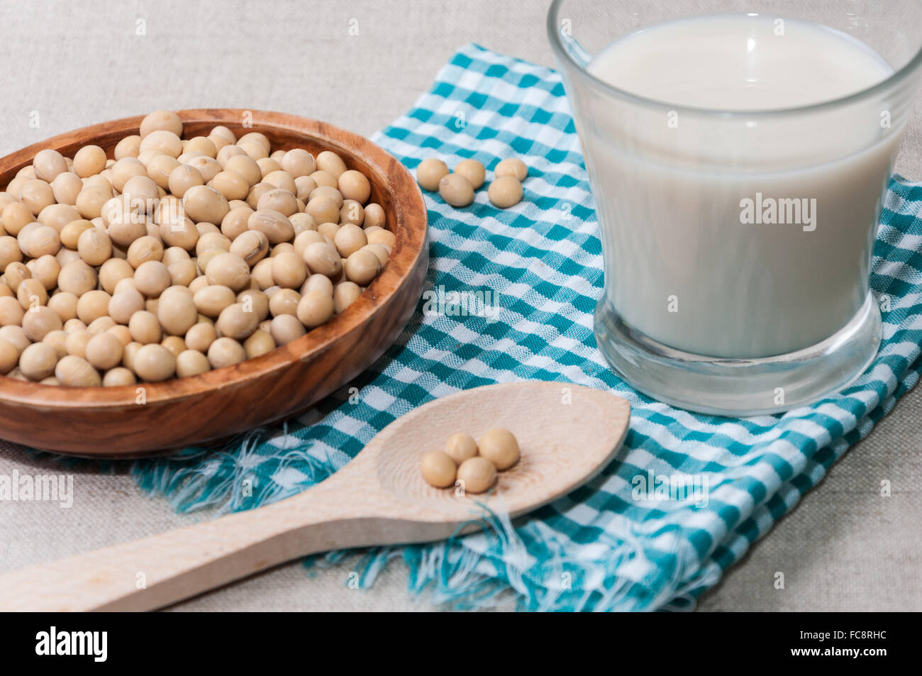 Glass of milk and bowl with soy Stock Photo