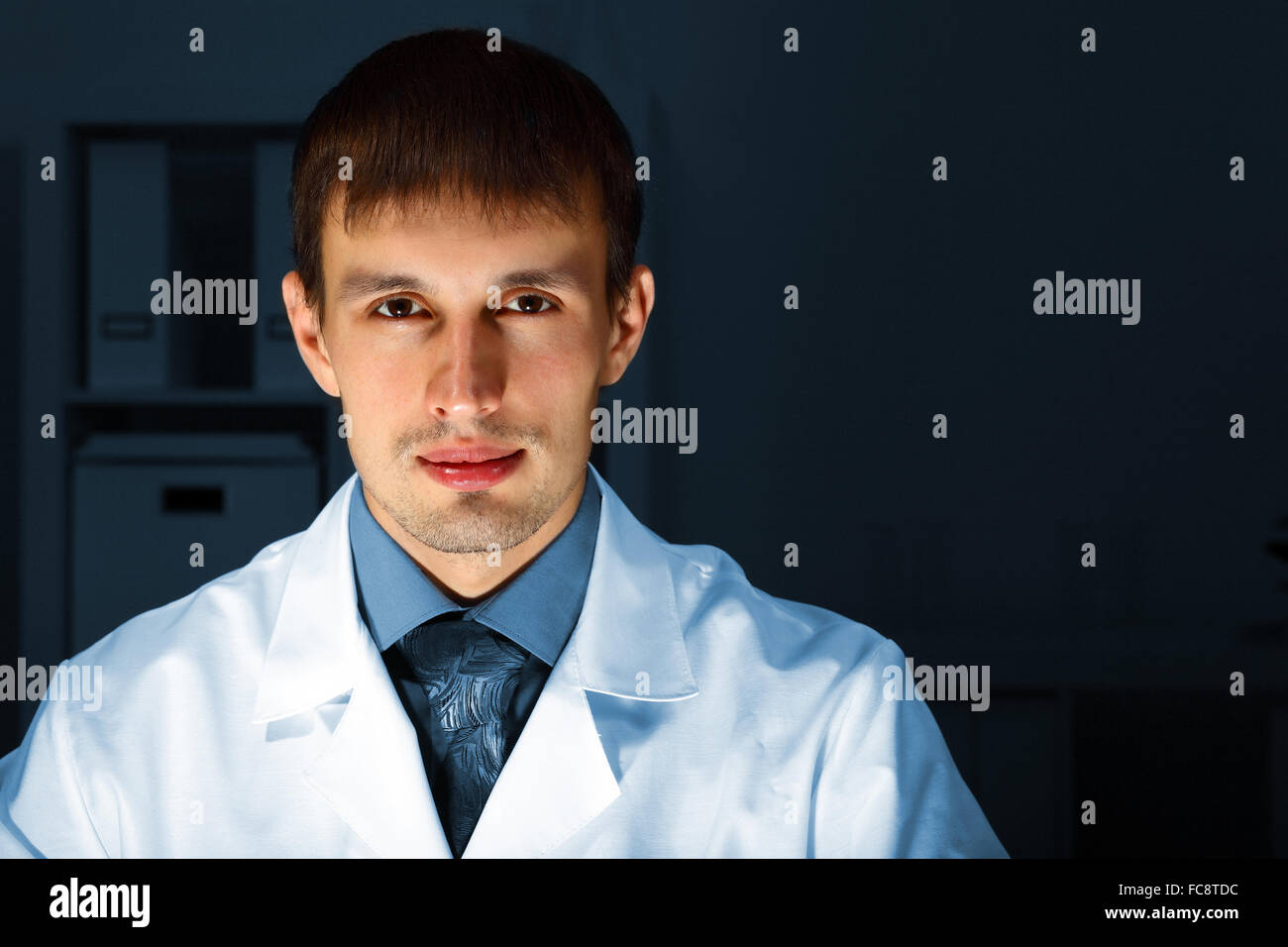 Young chemist in white uniform working in laboratory Stock Photo Alamy