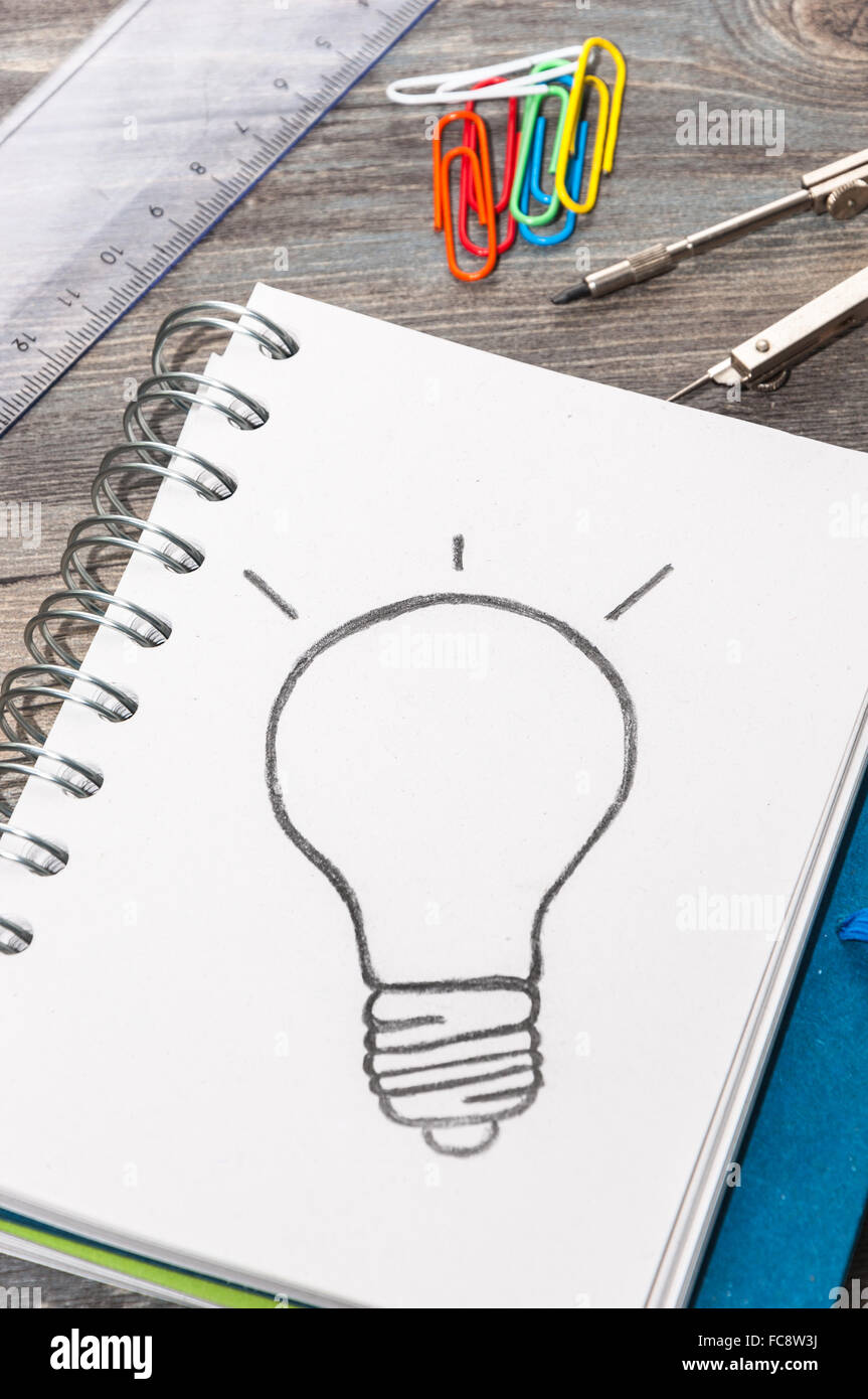 Drawing a bulb on a notepad Stock Photo - Alamy