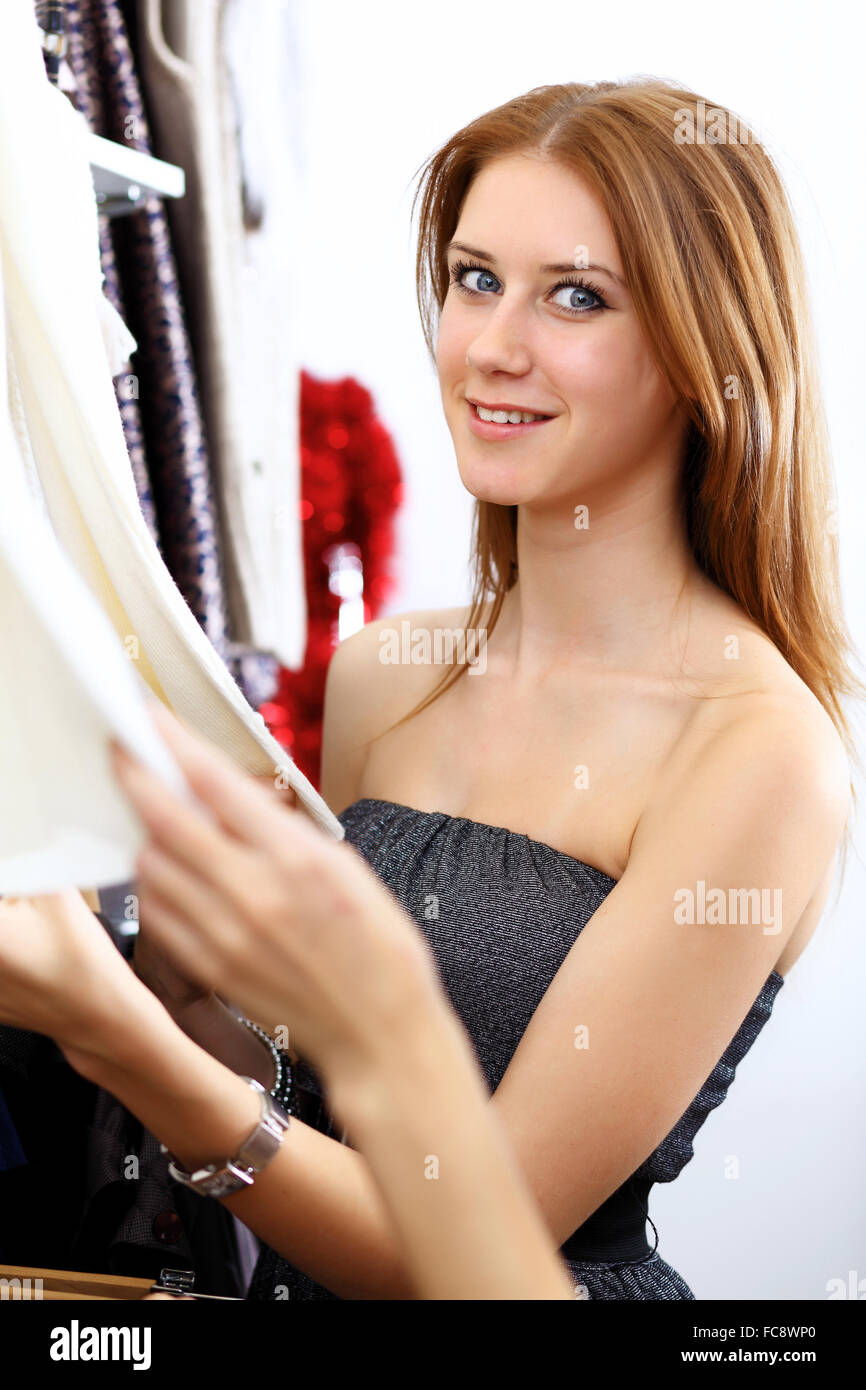 Portrait of young woman inside a store buying clothes Stock Photo - Alamy