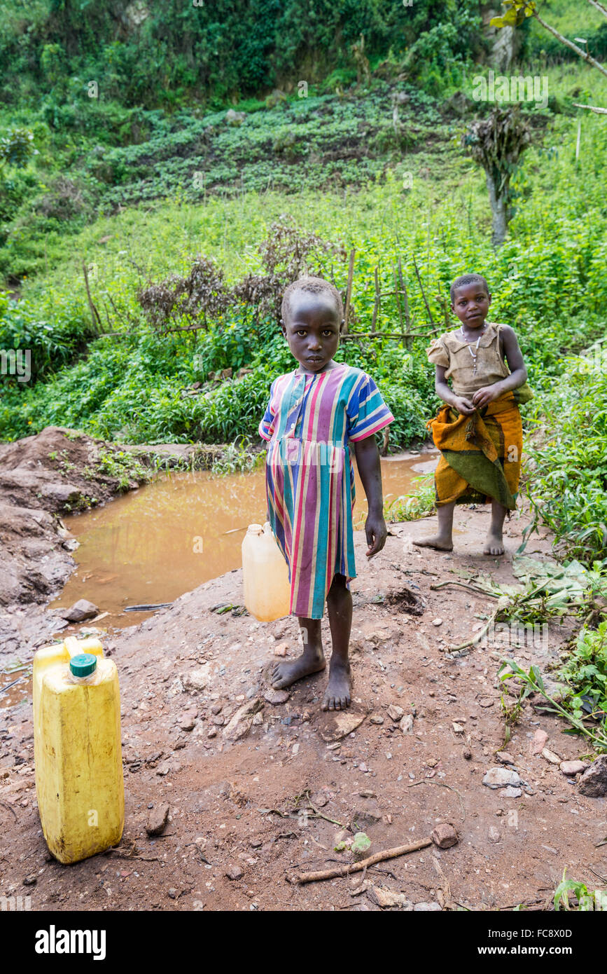 Children fetch fresh drinking water at a river, Kabala district, Uganda