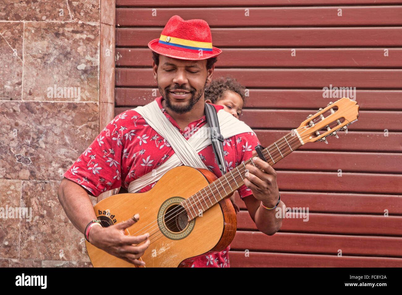 Street musician and his family playing music in Quito, Ecuador. Stock Photo
