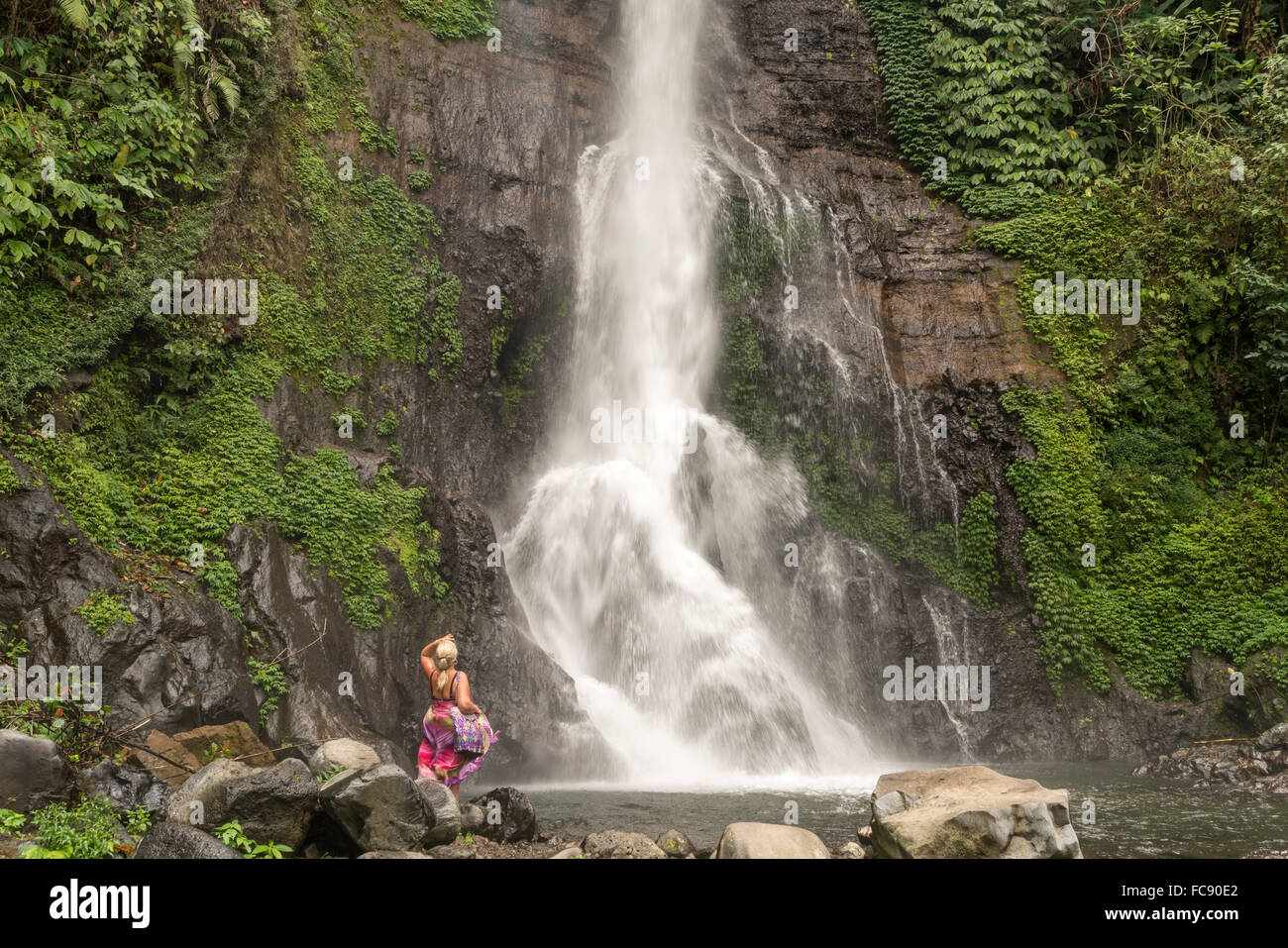 tourist watching the Gitgit Waterfall, Bali, Indonesia Stock Photo