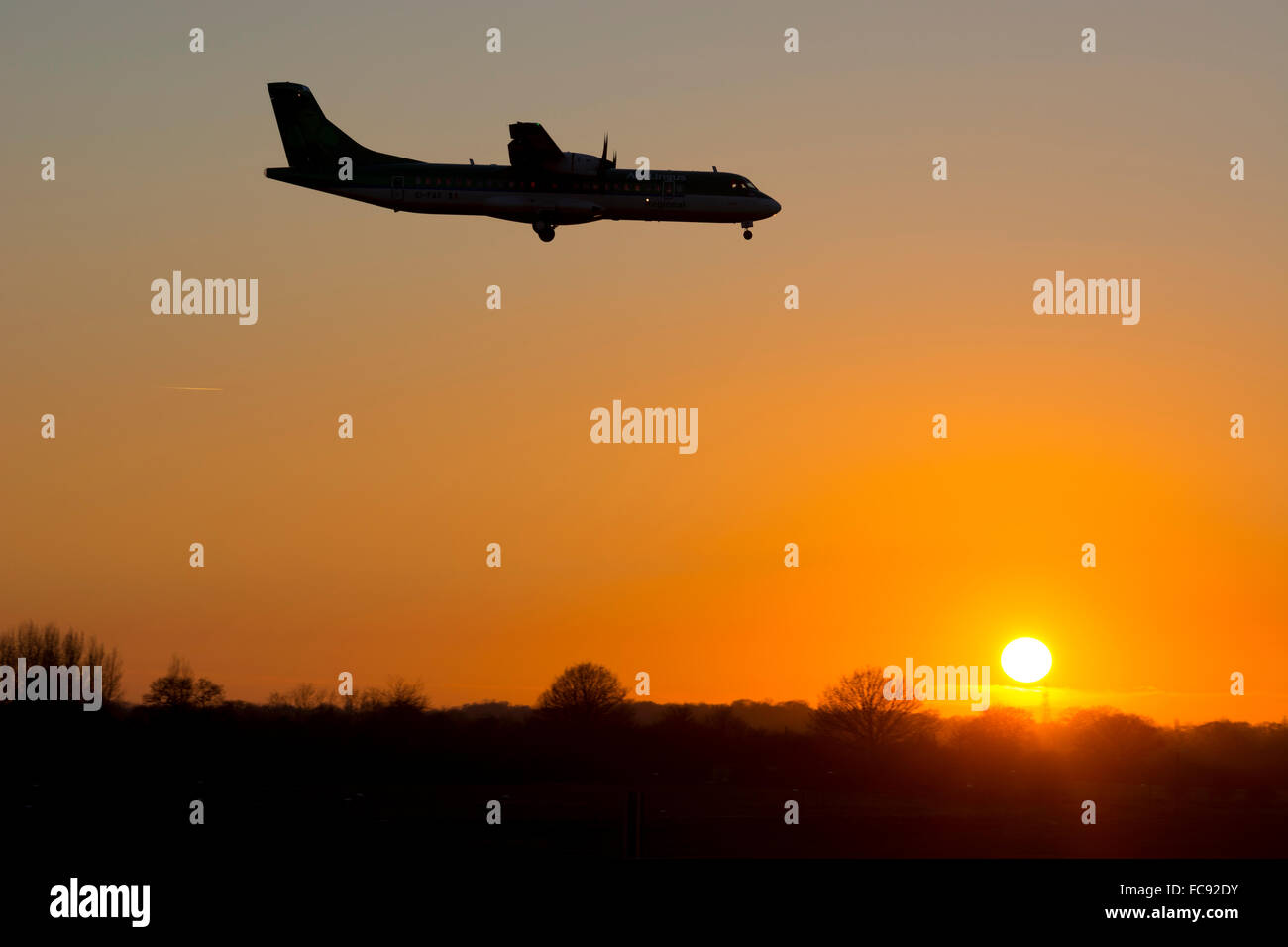 Aer Lingus Regional ATR-72 landing at sunset, Birmingham Airport, UK Stock Photo