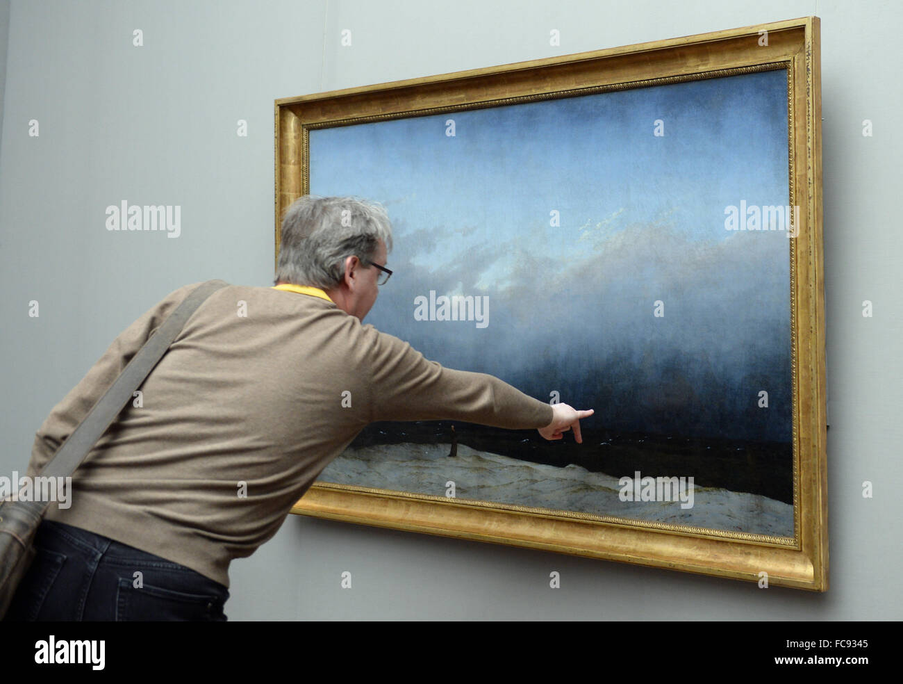 Berlin, Germany. 21st Jan, 2016. A visitor looks at the restored 'The Monk by the Sea' by painter Caspar David Friedrich (1774 - 1840) in the Alte Nationalgalerie in Berlin, Germany, 21 January 2016. The painting was restored from 2013 to 2016 and will be shown from 22 January to 22 May 2016 in a special presentation. Photo: BRITTA PEDERSEN/dpa/Alamy Live News Stock Photo
