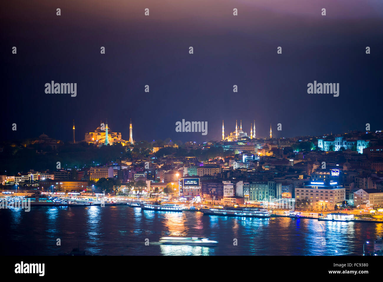 Blue Mosque and Hagia Sophia (Aya Sofya) at night seen from The Galata Tower across the Bosphorus Strait, Istanbul, Turkey Stock Photo