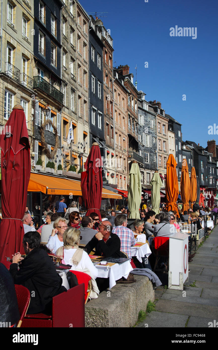 Diners lunching in restaurants at water's edge, Vieux Bassin, Old Port, Honfleur, Normandy, France, Europe Stock Photo