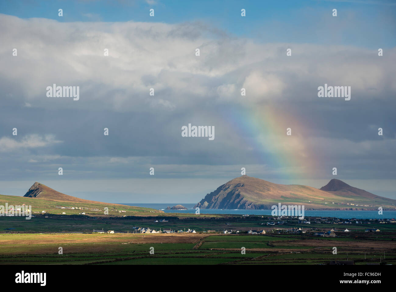Rainbow over hills and dwellings, looking towards Clogher and Rosroe, Dingle Peninsula, County Kerry, Munster, Republic of Irela Stock Photo