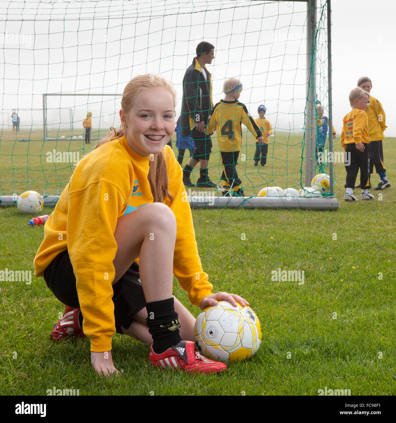 Young teenager playing football, Akranes, Iceland Stock Photo