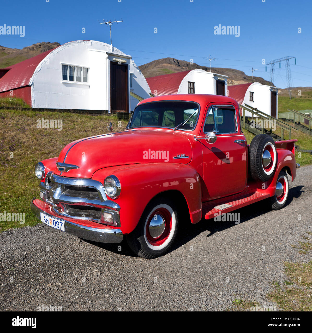 Old Chevrolet pickup truck in front of old summer cabins, Hvalfjordur, Iceland Stock Photo