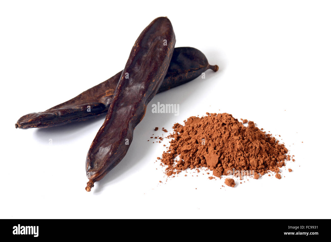 Ripe carob pods and carob powder, can be used as a substitute for cocoa Stock Photo
