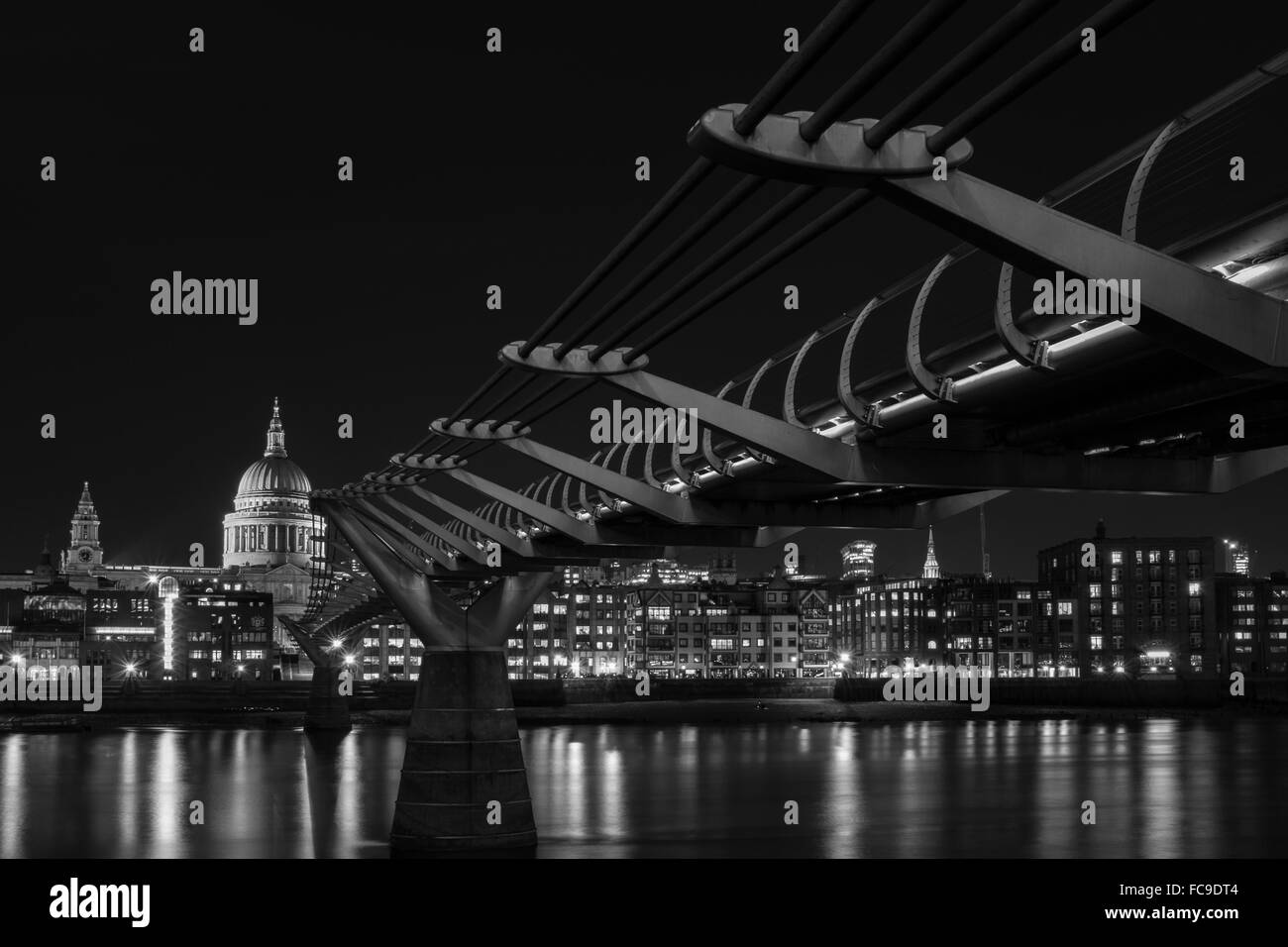 London Black and White urban photography: cityscape of Millennium Bridge, St. Paul's Cathedral and River Thames at night. Stock Photo