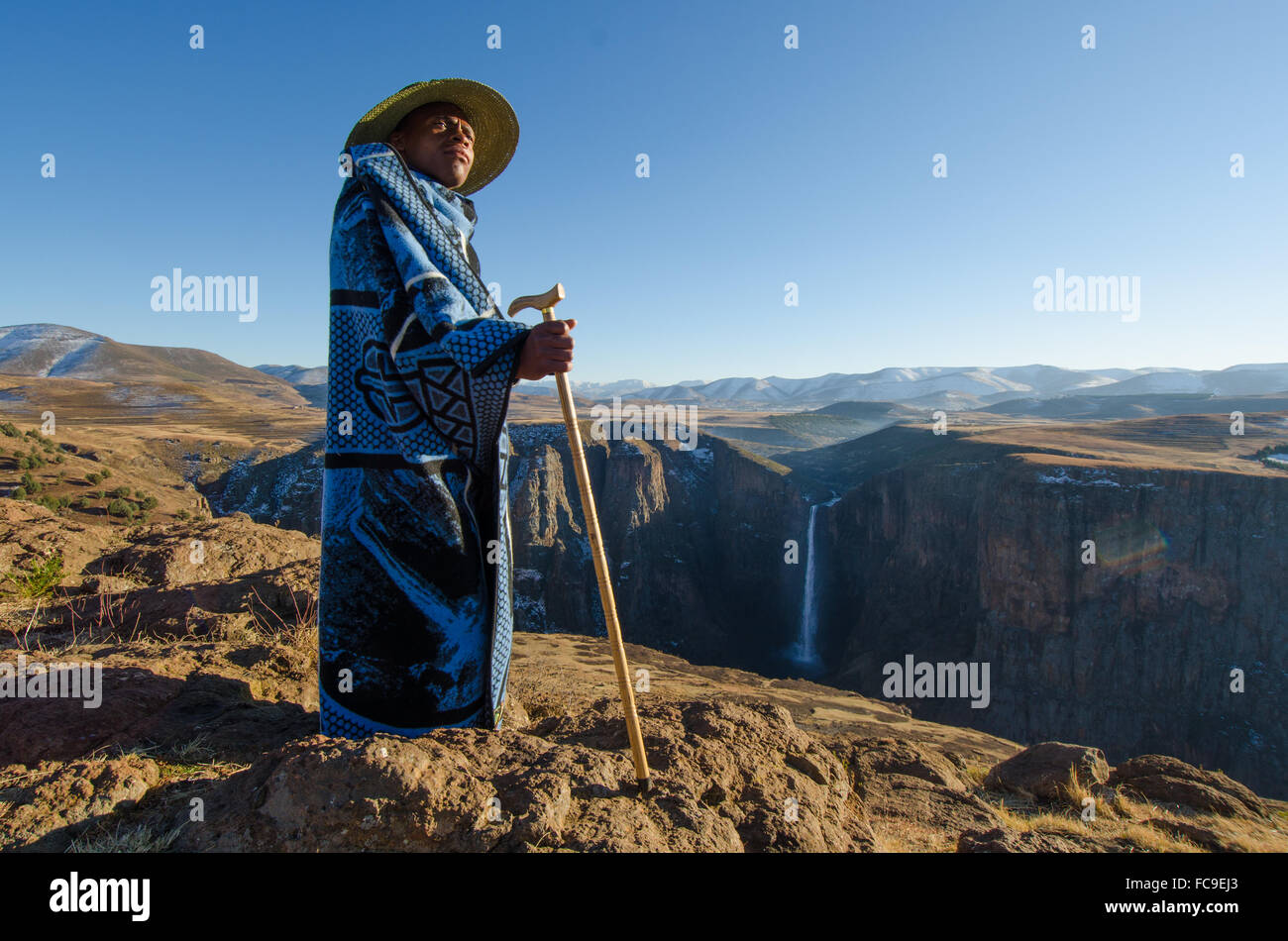 A local sheep shepherd converges on the cliffs of Maletsunyane Falls in rural Lesotho. Stock Photo