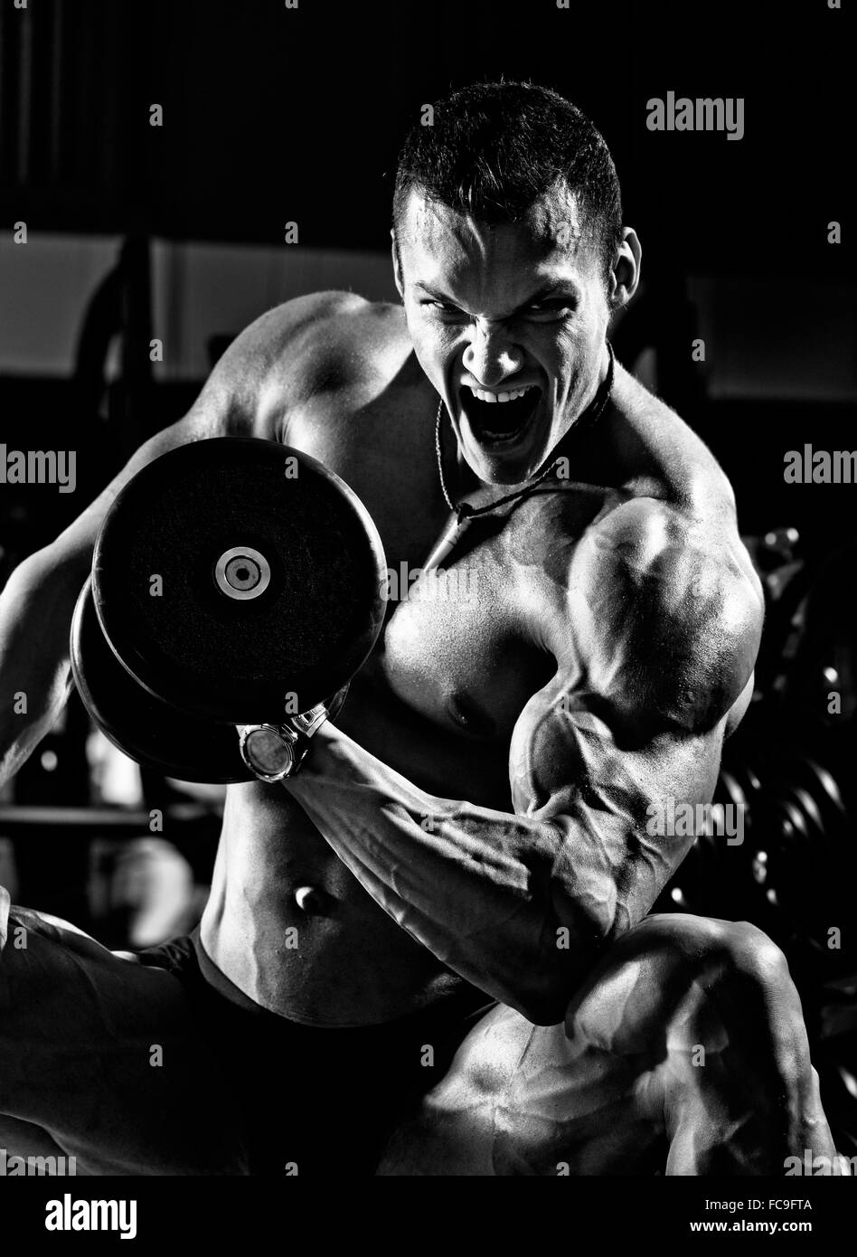 Bodybuilder training arm Black and White Stock Photos & Images - Alamy