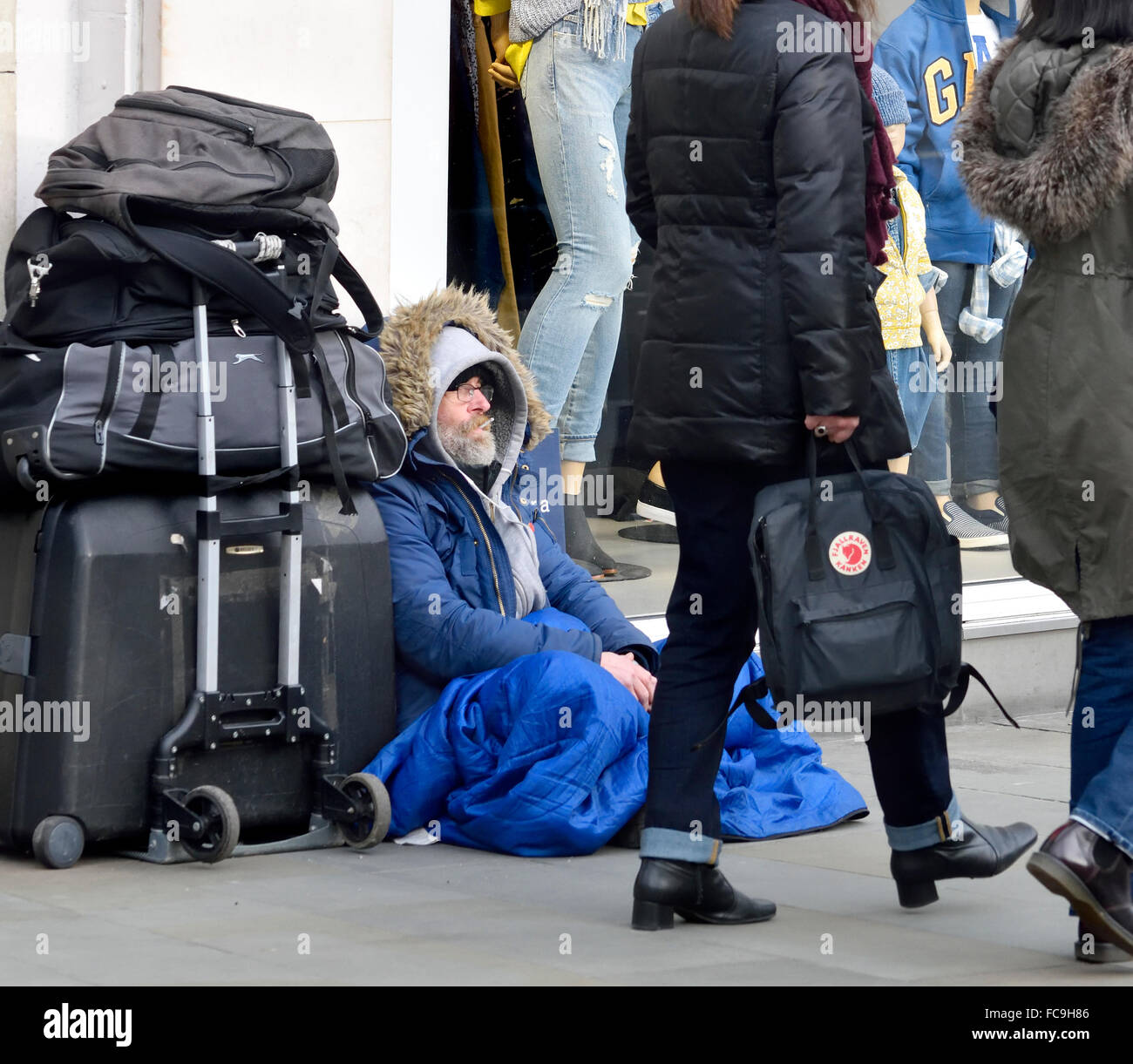 London, England, UK. Homeless man sleeping rough in Piccadilly Circus by Gap  shop Stock Photo - Alamy