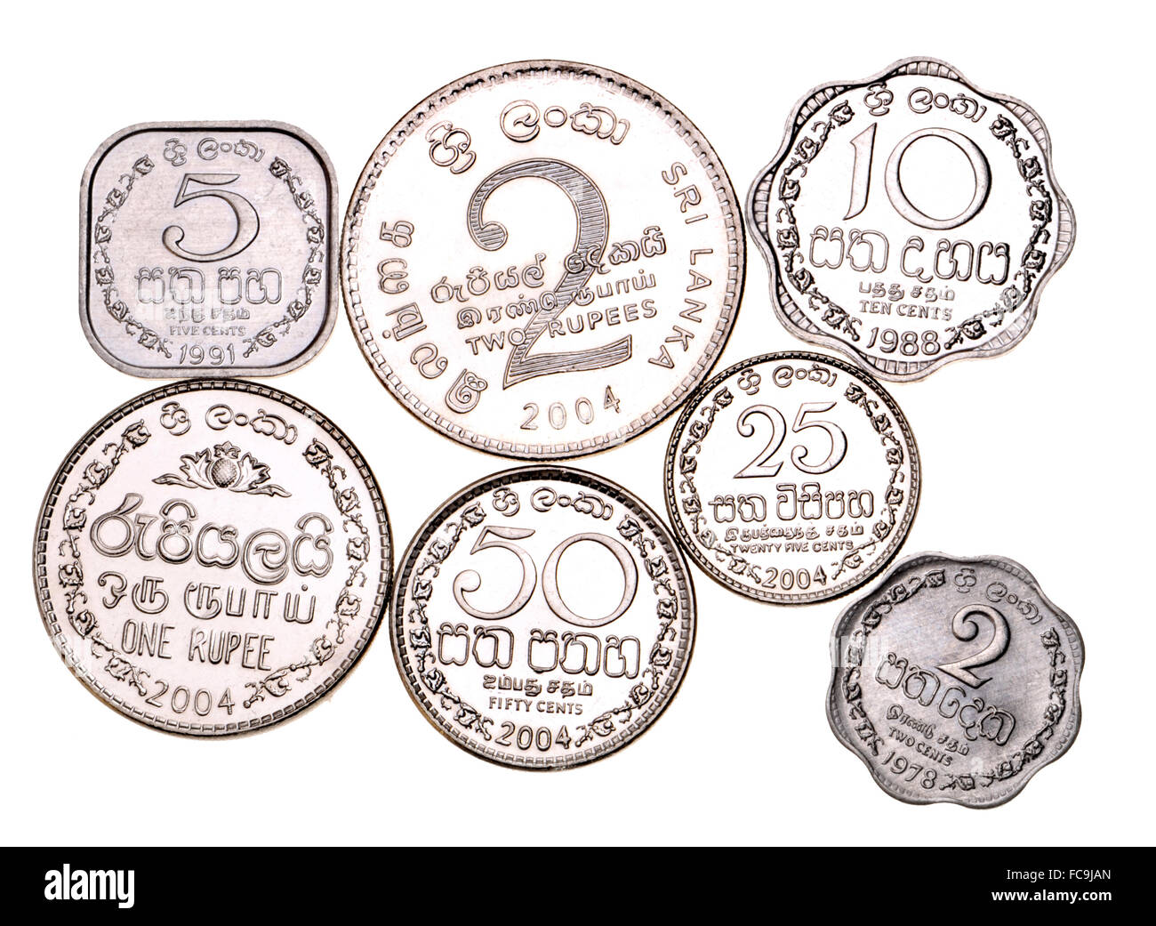 Sri Lankan coins (no longer legal curency, except 2 Rupees) showing the Sinhala / Sinhalese alphabet Stock Photo