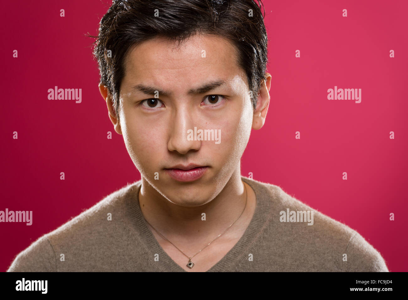 A headshot of a young handsome Japanese man. Stock Photo
