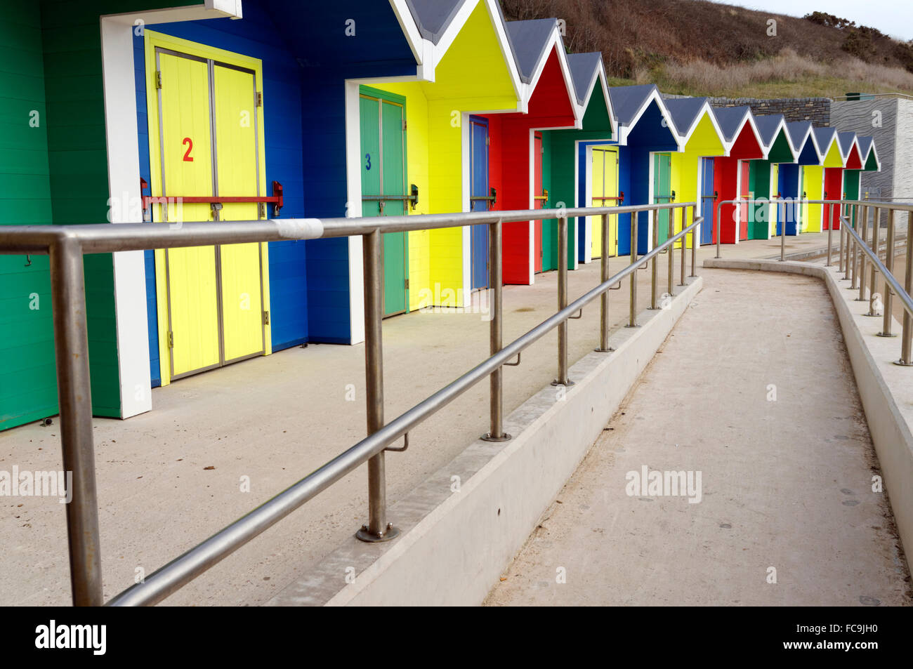 New brightly coloured beach huts, Whitmore Bay, Barry Island, Vale of Glamorgan, South Wales, UK. Stock Photo