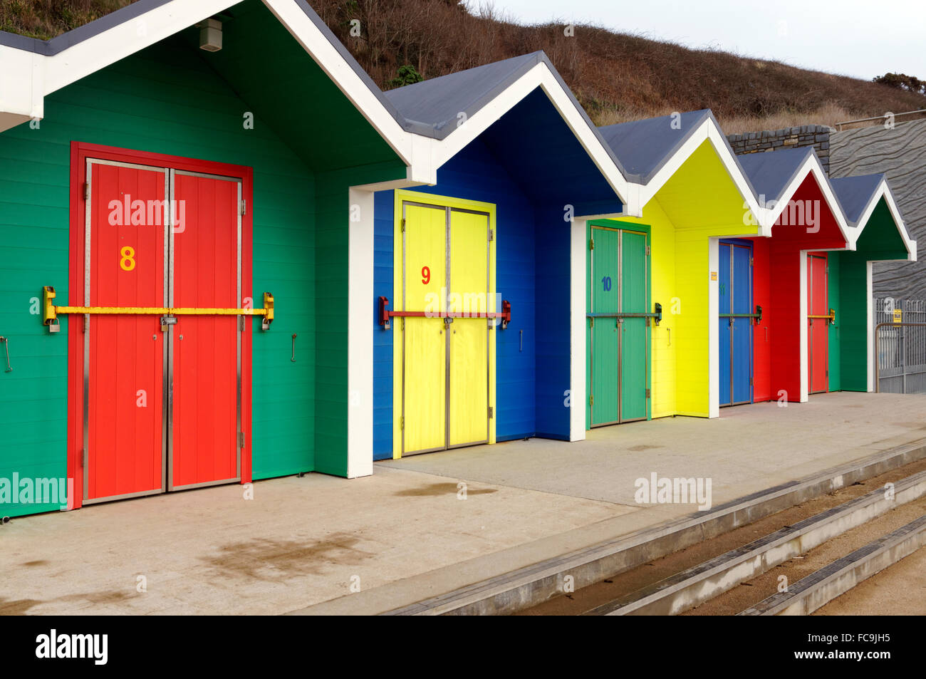 New brightly coloured beach huts, Whitmore Bay, Barry Island, Vale of Glamorgan, South Wales, UK. Stock Photo