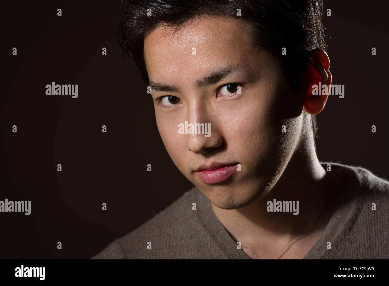 A headshot of a young handsome Japanese man. Stock Photo
