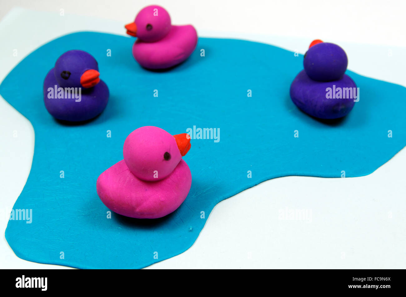 Rubber ducks on imitation pond. Stock Photo
