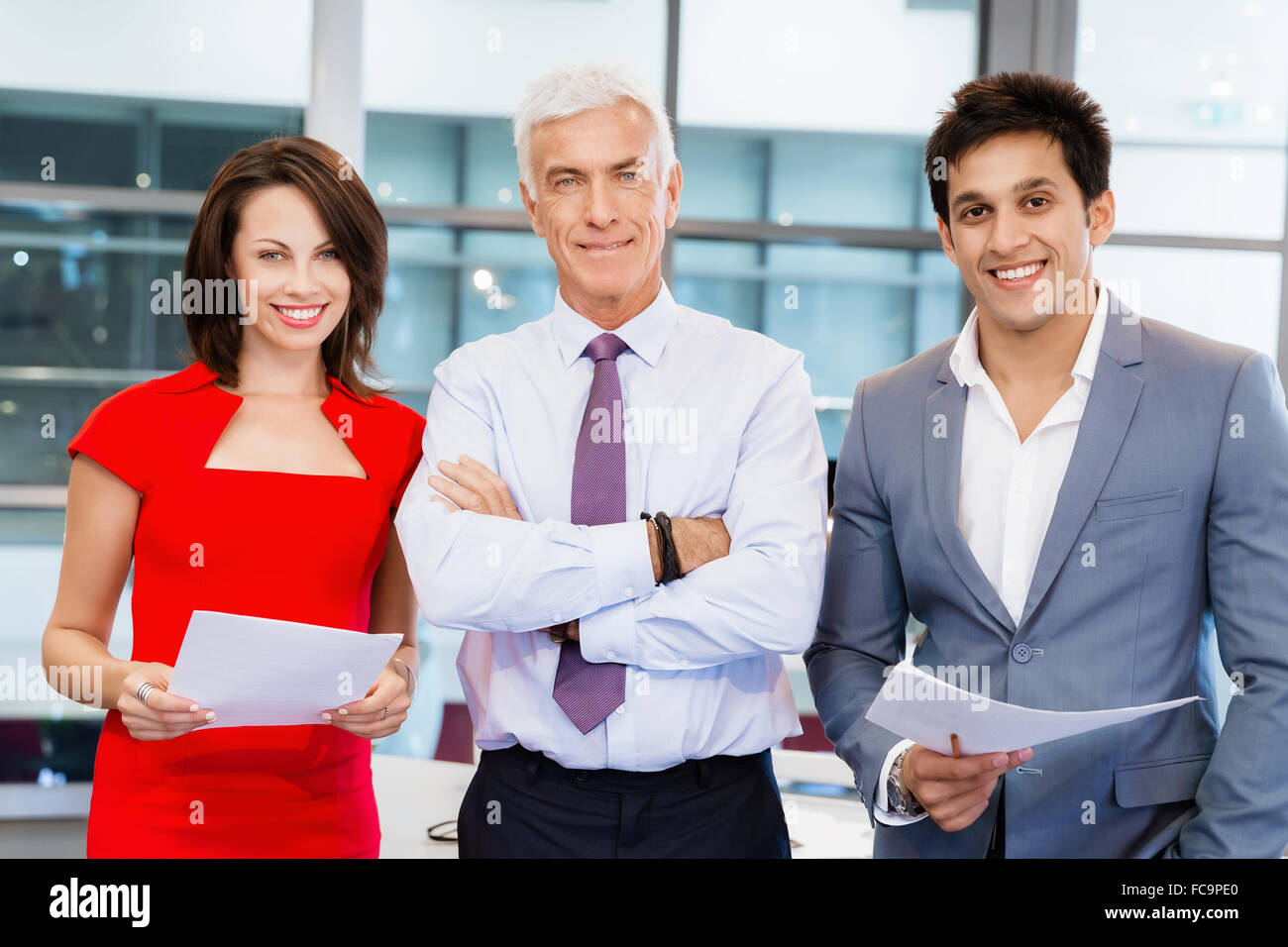 Group of businesspeople in office standing Stock Photo - Alamy