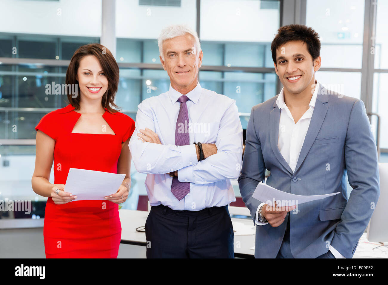 Group of businesspeople in office standing Stock Photo - Alamy