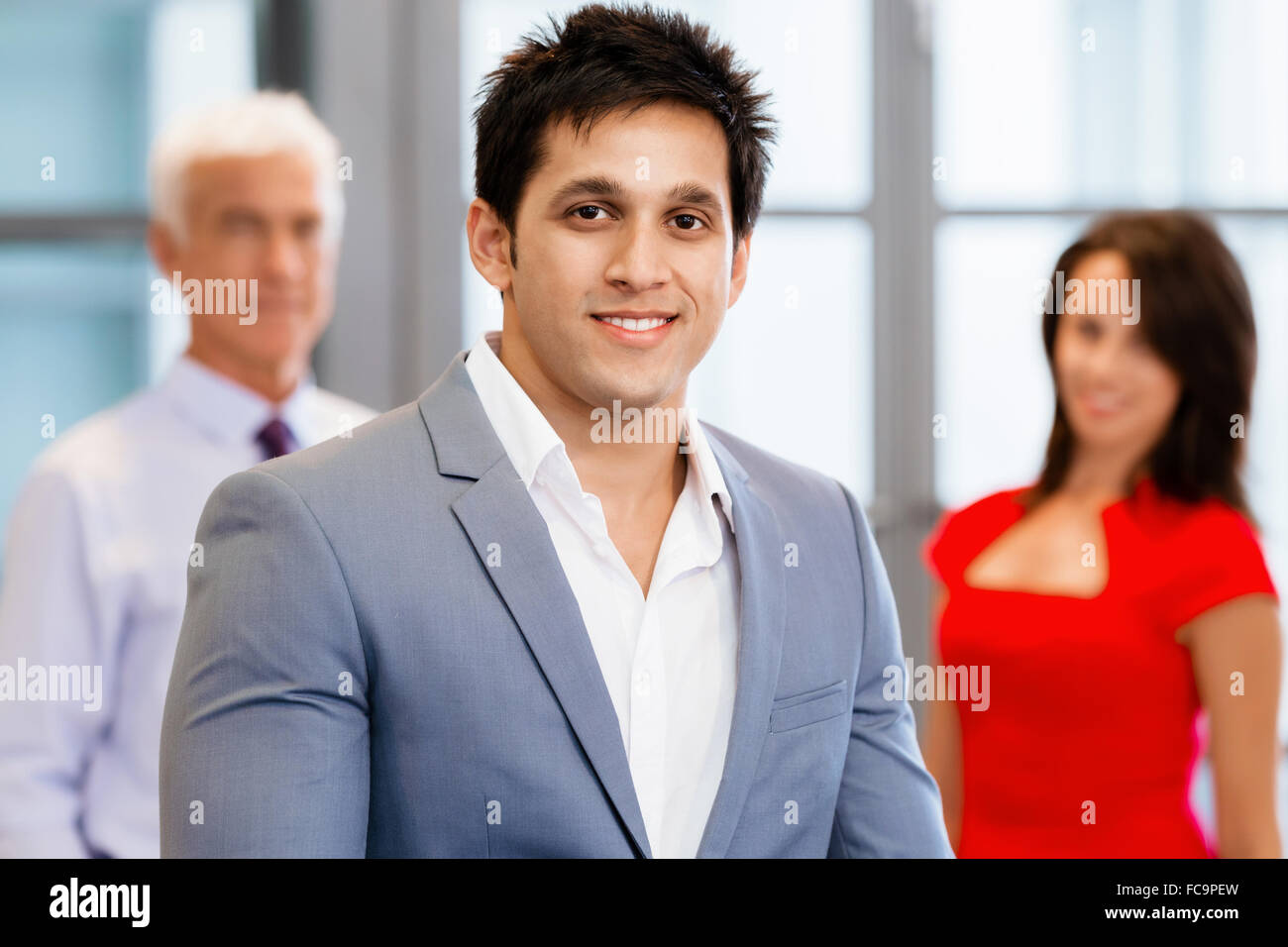 Group of businesspeople in office standing Stock Photo - Alamy
