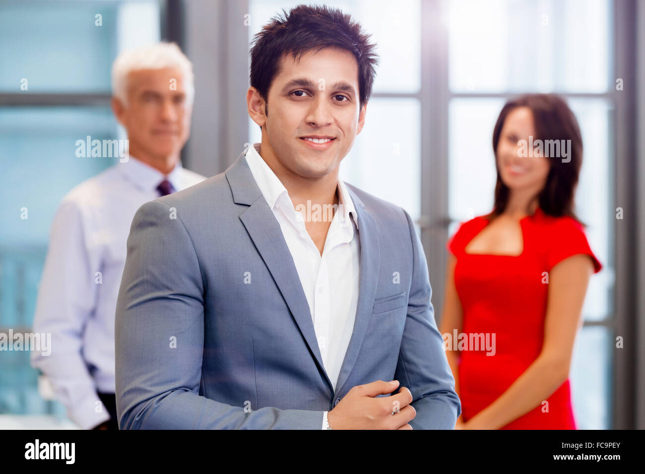 Group of businesspeople in office standing Stock Photo - Alamy