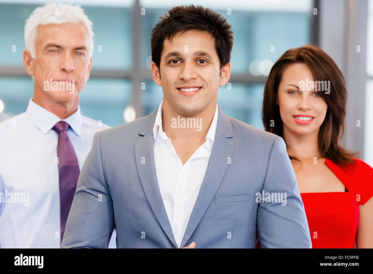 Group of businesspeople in office standing Stock Photo - Alamy