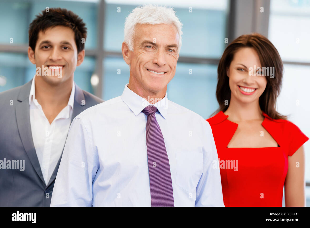 Group of businesspeople in office standing Stock Photo - Alamy