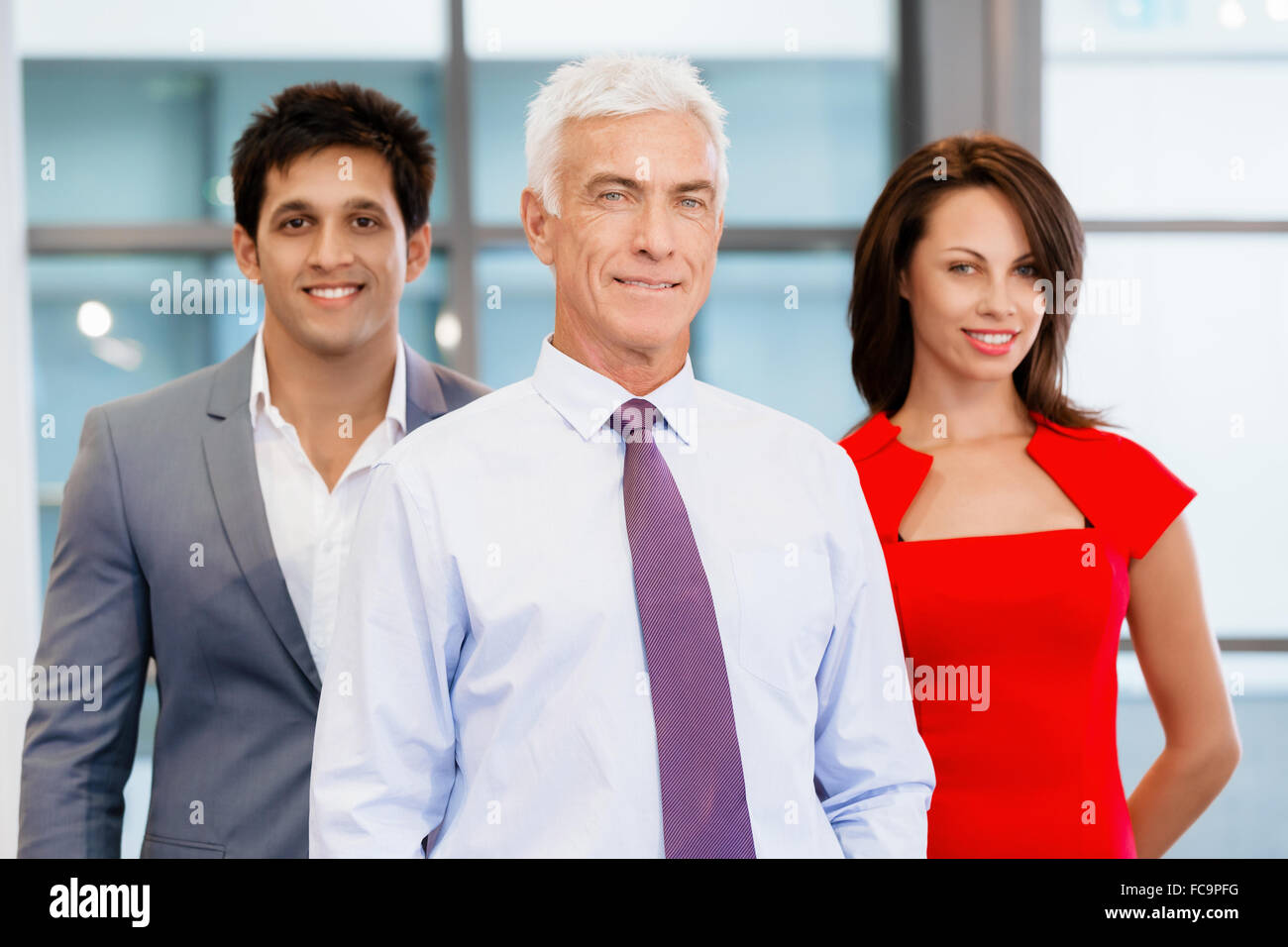 Group of businesspeople in office standing Stock Photo - Alamy