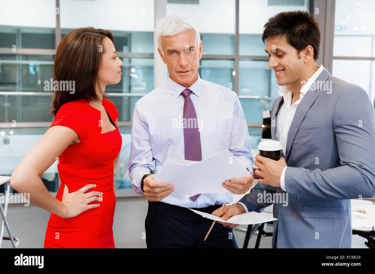 Group of businesspeople in office standing Stock Photo - Alamy