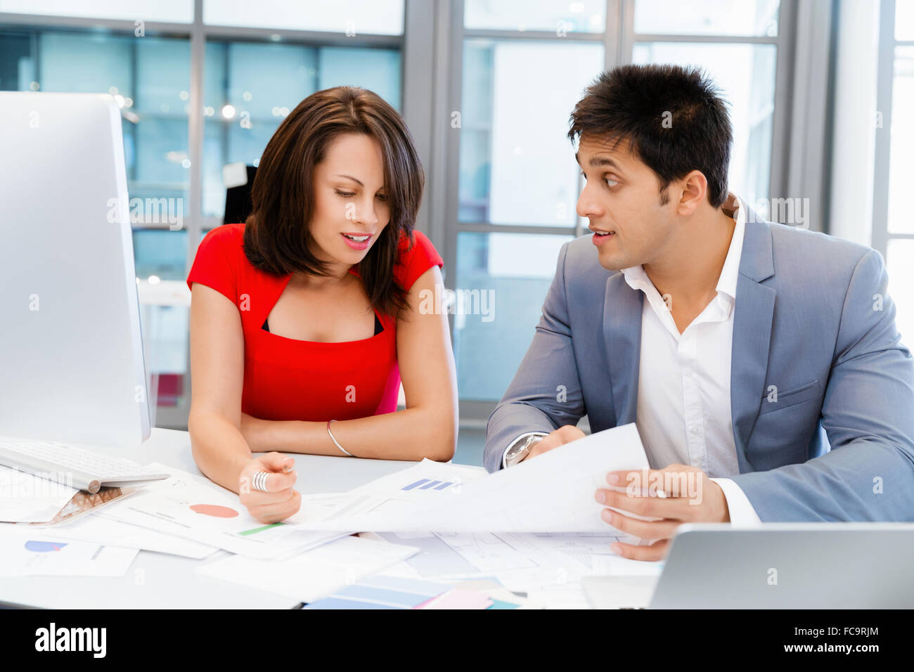 Two young business collegue talking in office Stock Photo - Alamy