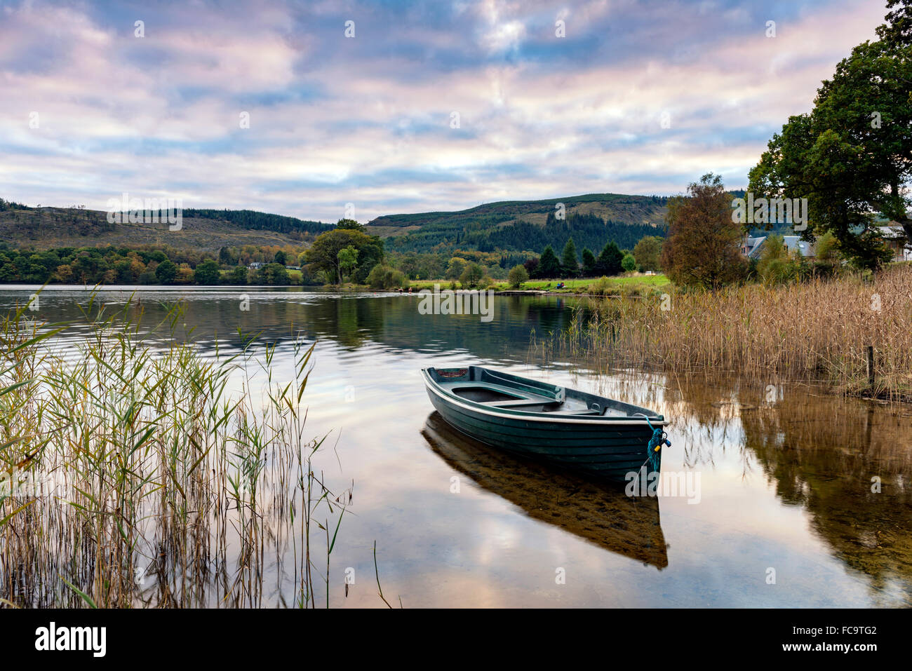 Evening light on a rowing boat on the banks of Loch Ard in the Trossachs Stock Photo