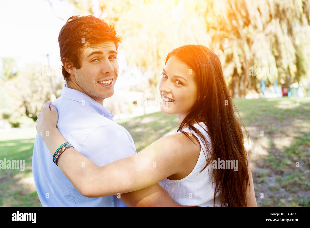 Young happy couple in the park in the summer Stock Photo - Alamy