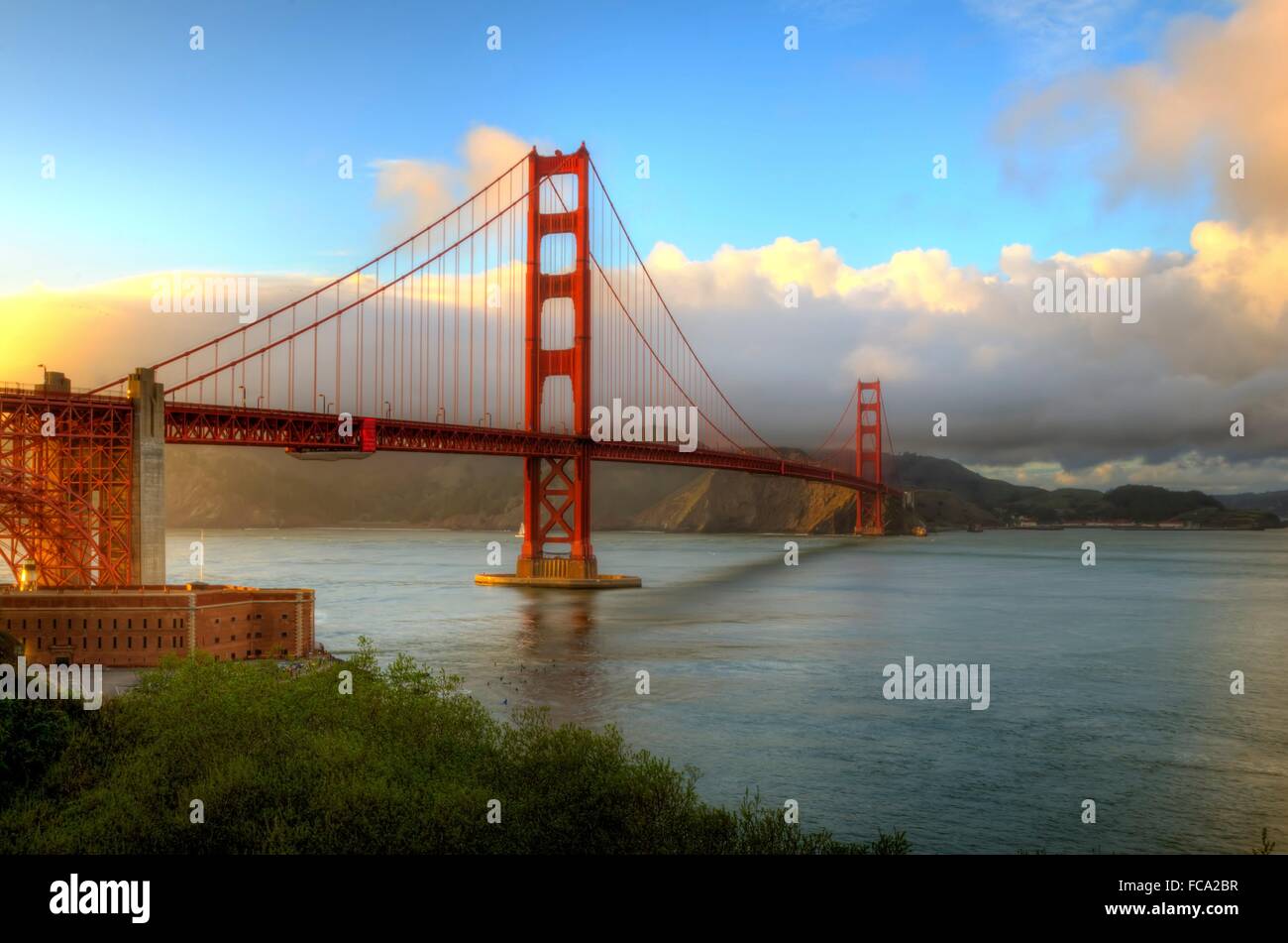 The famous San Francisco Golden Gate Bridge in California, United States of America. A view of Fort Point, the bay, surfers and  Stock Photo