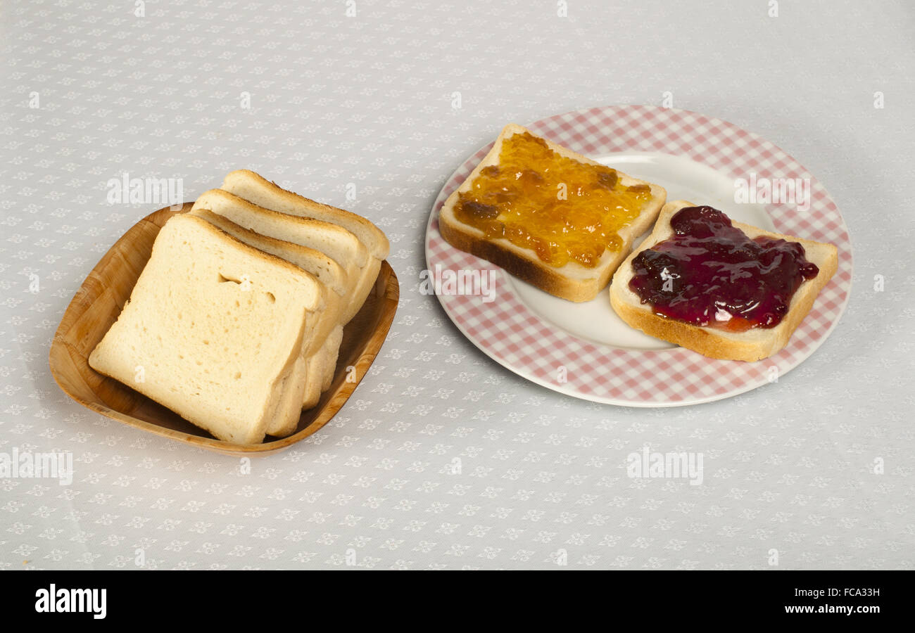 Spread jam on bread Stock Photo Alamy