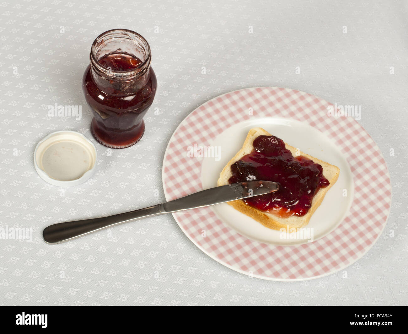 Spread jam on bread Stock Photo Alamy