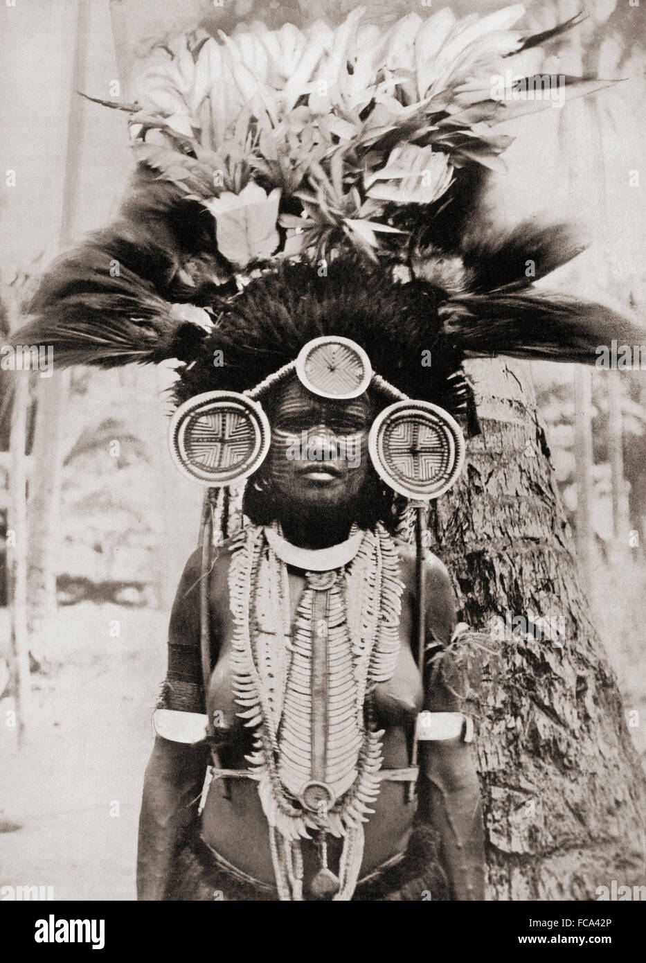 A woman of the Roro tribe from Papua New Guinea, Melanesia, decorated for a ceremonial dance.  From a 19th century photograph. Stock Photo
