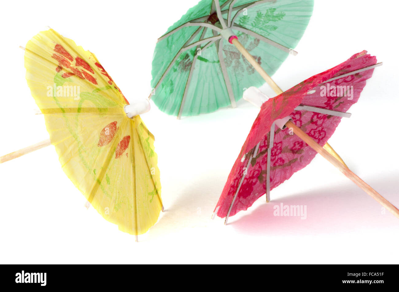 Colorful cocktail umbrellas white isolated Stock Photo